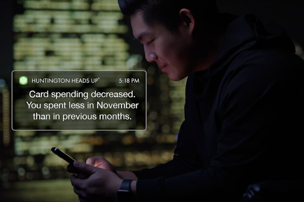 man looking at phone alert message