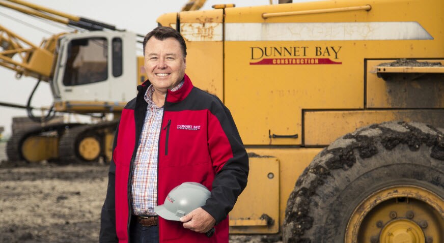 Tod W. Faerber with Dunnet Bay Construction equipment.