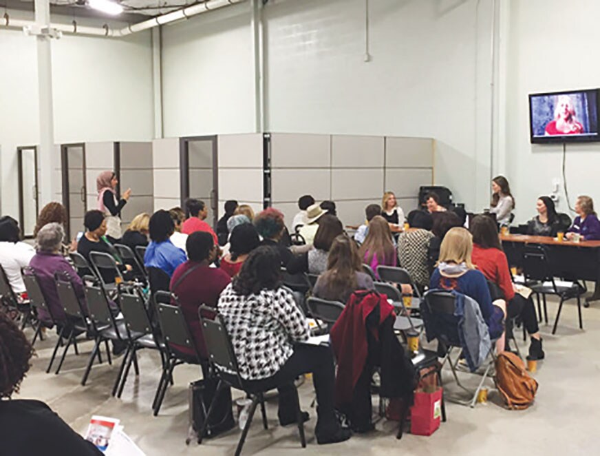 An EDCI meeting with audience members and a panel.
