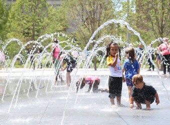 Children playing in a fountain in Public Square.