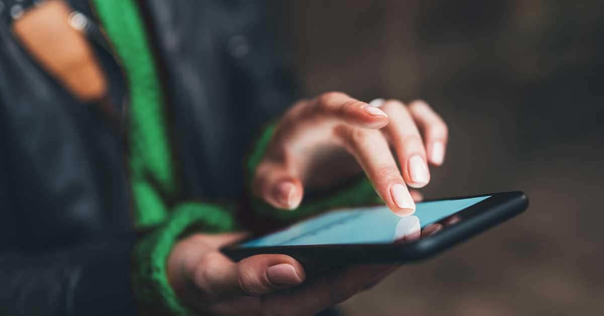 a woman activates her debit card using her smartphone