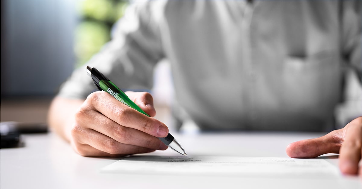 Close up of a man filling out a money order