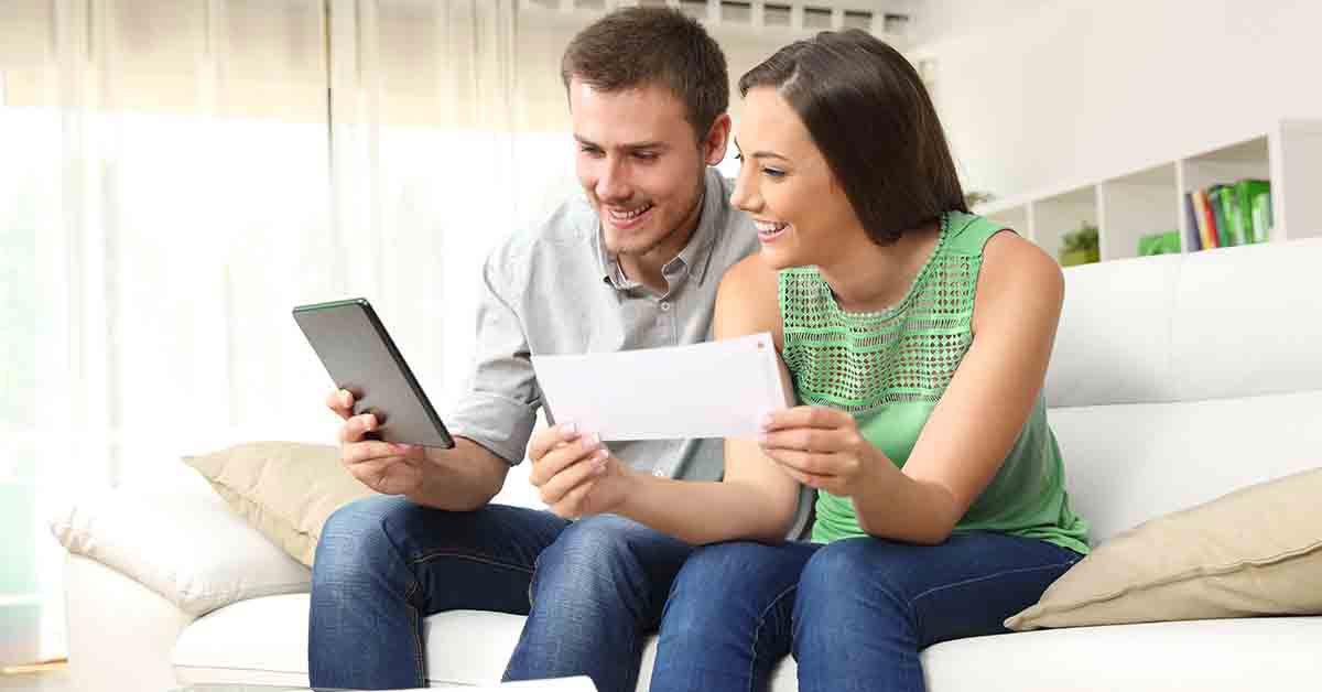 a couple looks up how to read a check on a tablet