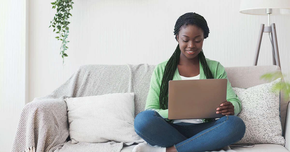 a young woman transfers funds on her laptop
