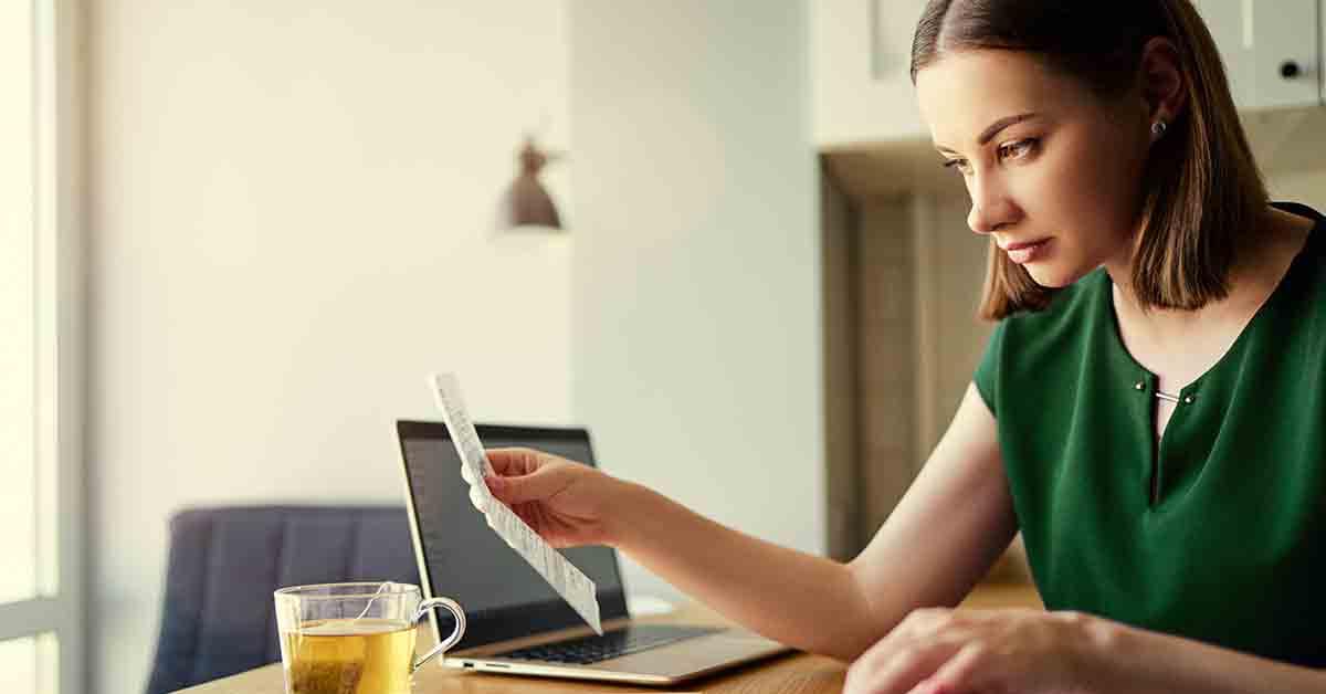 a young woman looks at her bank statement