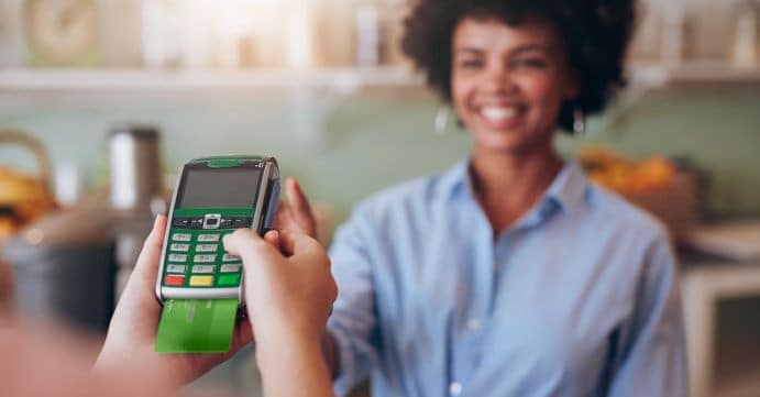 Women using credit card at store