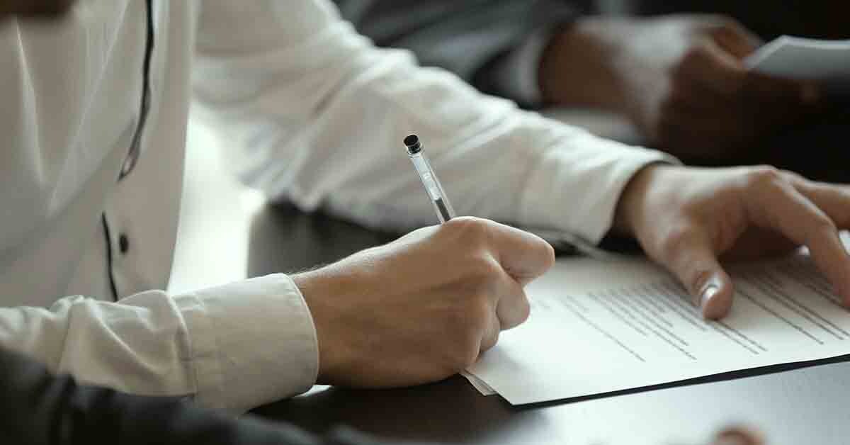 someone fills out insurance paperwork