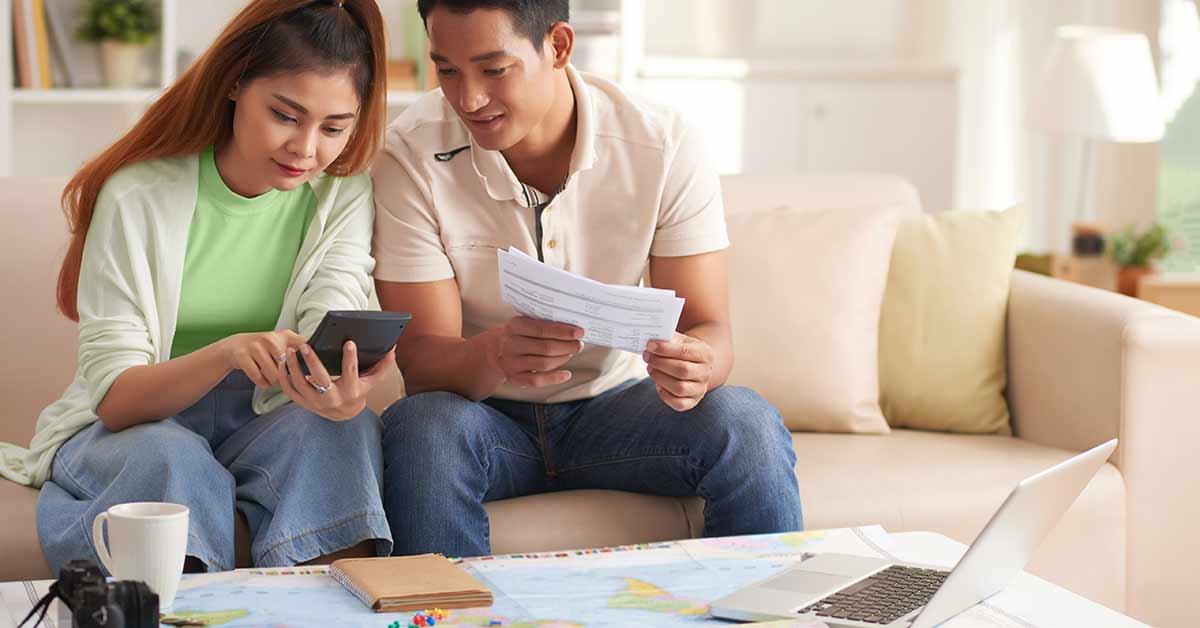 couple calculating vacation costs
