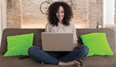 Woman sitting on couch with laptop
