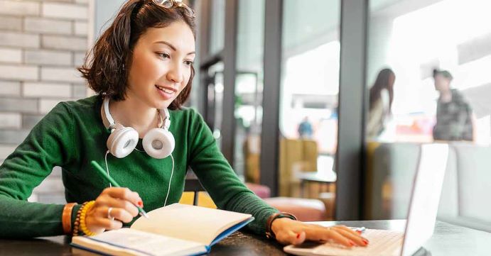 Women in green shirt creating a budget