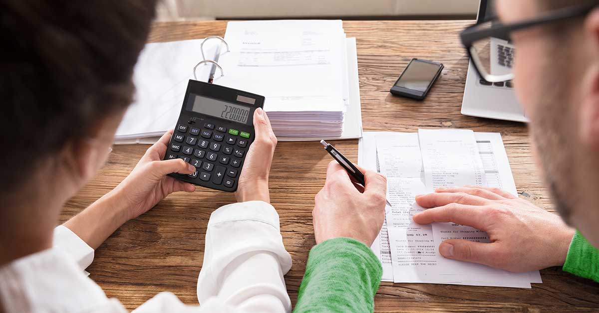 Couple looking at calculator 