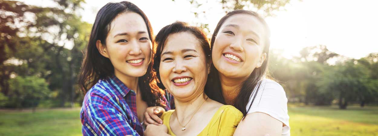 Family hugging outdoors
